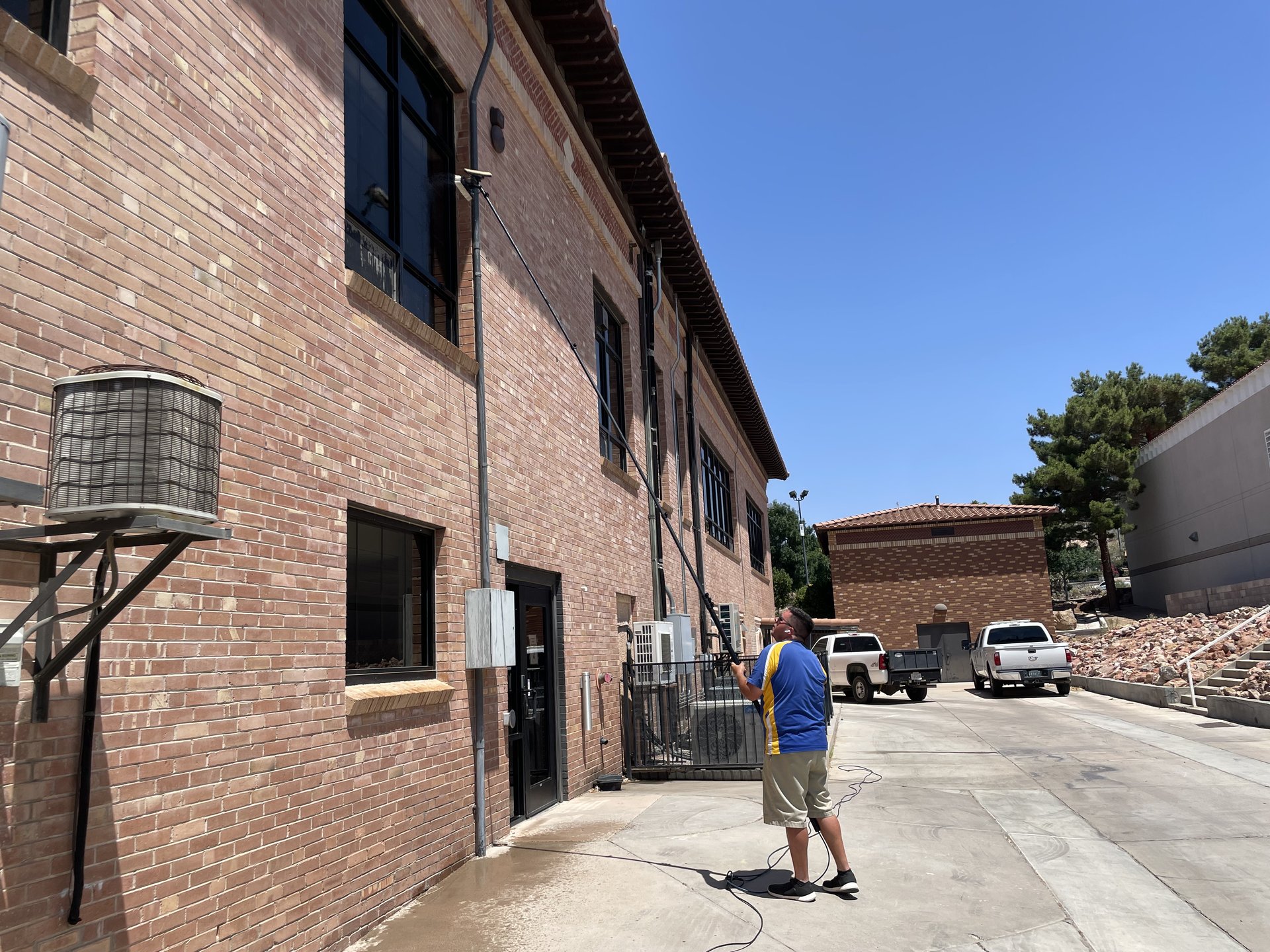 Commercial window cleaning with water fed pole on multi-story building