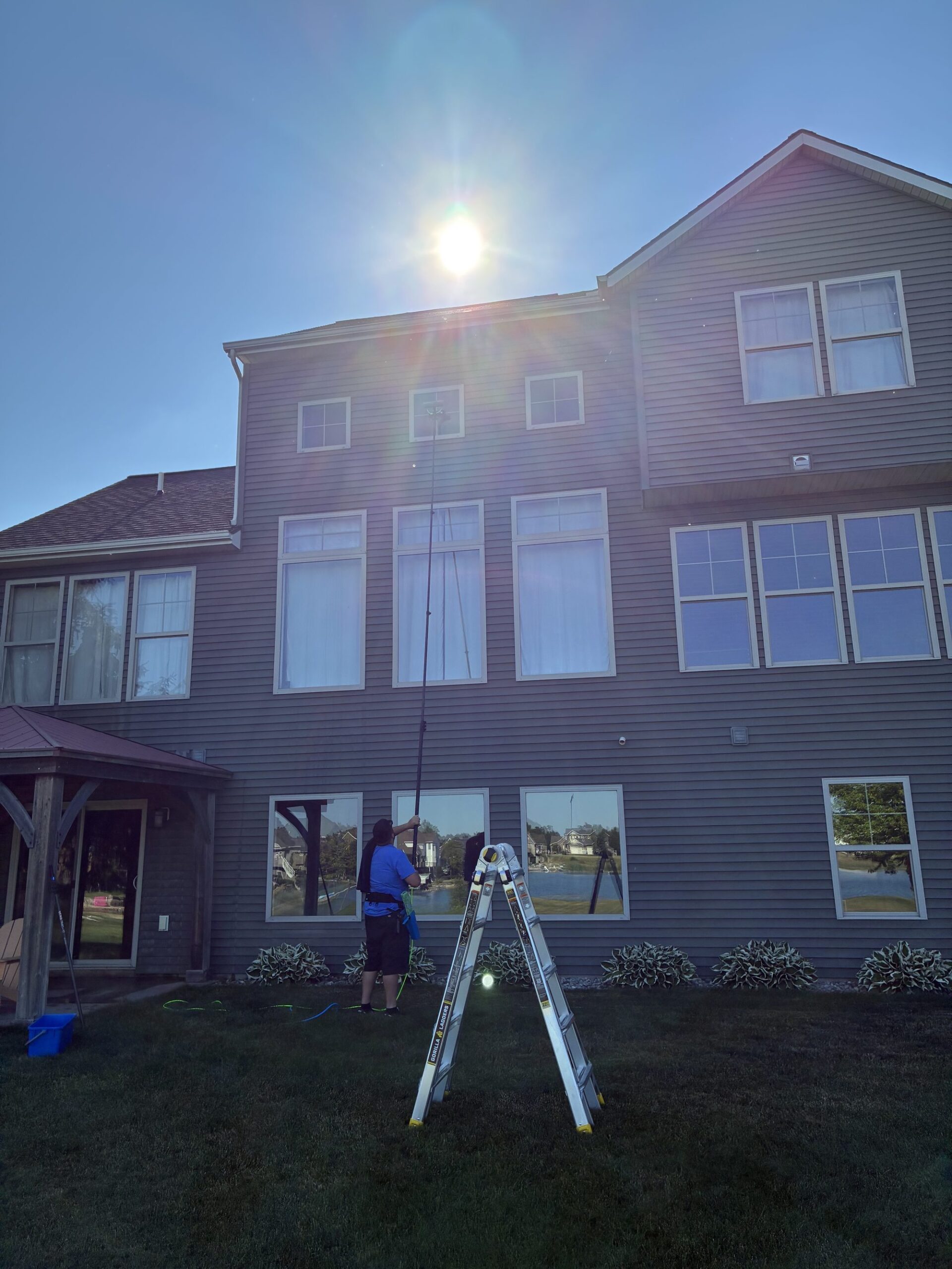 Moonwalker Window Cleaning crew cleaning windows in Spring Lake MI